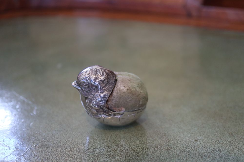 An Edwardian novelty silver mounted pin cushion modelled as a hatching chick, Sampson Mordan & Co